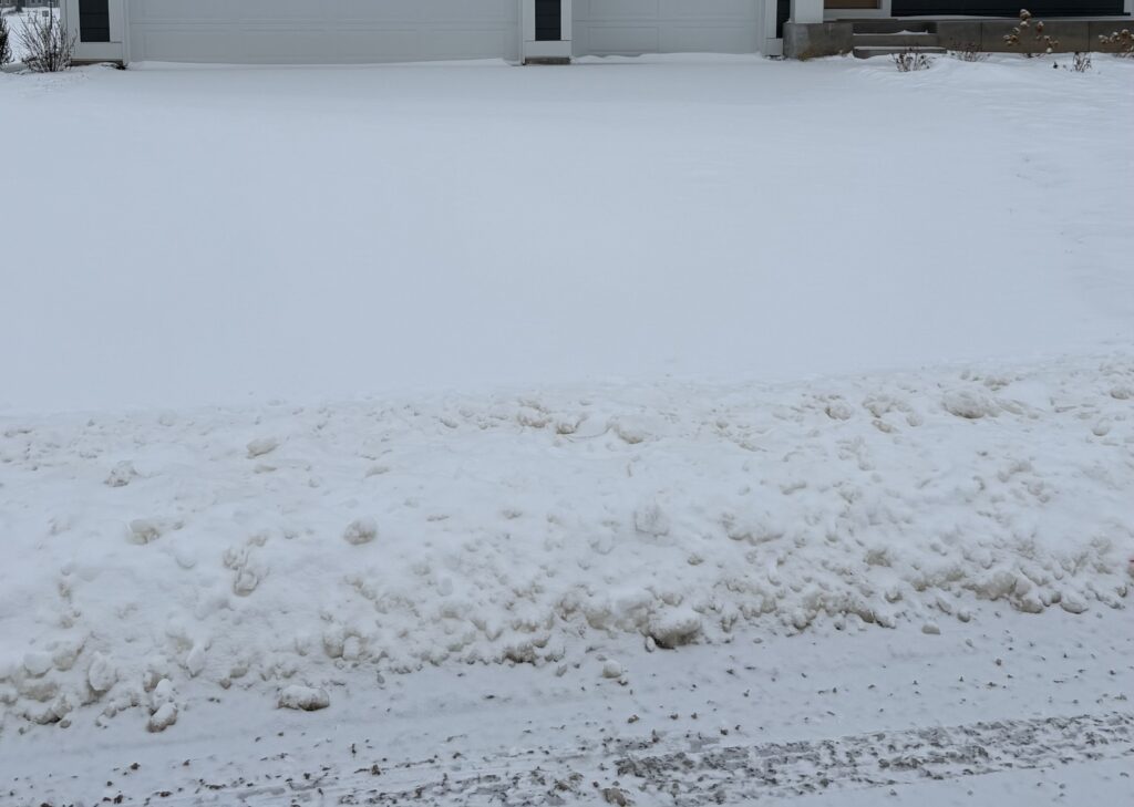 Residential driveway covered with snow